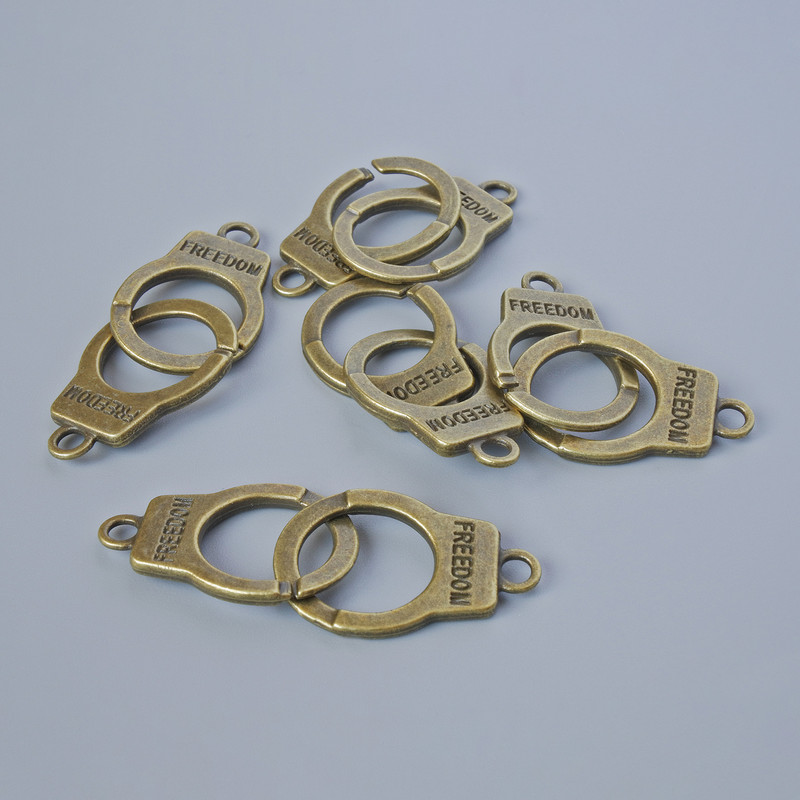 Schmuckanhänger „Handschellen“, Maße 23×14 mm, Dicke 5 mm, Lochdurchmesser 2,4 mm, Länge 40 mm, Verpackung 5 Stück ± Bronze-Farbton des Metalls