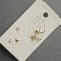 Ohrstecker und Ohrklemmen am Ohr – goldfarbenes Metall, weiße Strasssteine und Perle