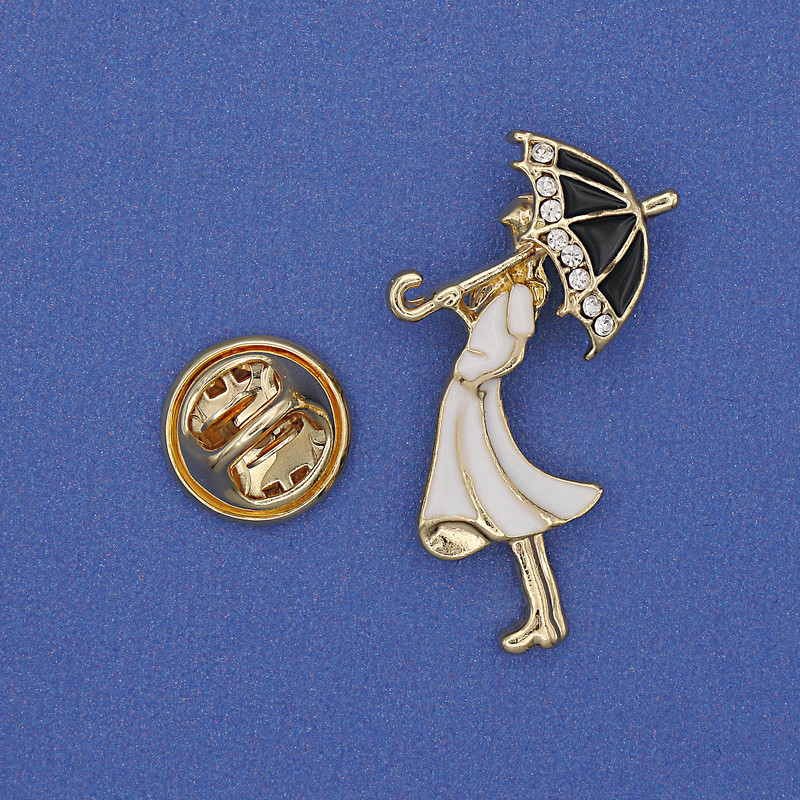 Brosche »Mädchen mit Regenschirm« weiße Strasssteine, weiße Emaille, goldfarbenes Metall, 32×16 mm+