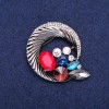 Reduziert! Rundbrosche 'Halo' mit Strasssteinen, zu einer schönen Komposition verwoben, dunkles Metall 45×50 mm