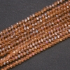 Perlen aus tschechischem Kristall, transparent bernsteinfarben mit Benzin-Finish, Rondell-Form, Durchmesser ca. 3,5 x 3 mm, Schnurlänge 38 cm