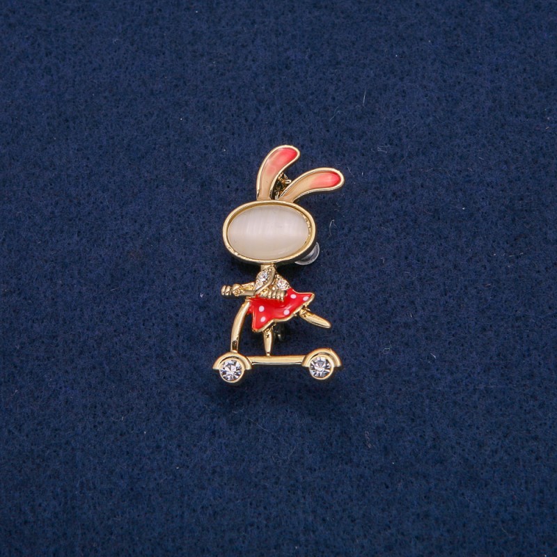 Brosche „Häschen auf dem Roller“ mit weißen Strasssteinen, goldfarbenem Metall, roter Emaille, Katzenauge-Cabochon (Katzenauge) 43x21mm +