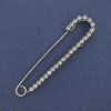 Silver-toned brooch pin with white rhinestones 72×16 mm