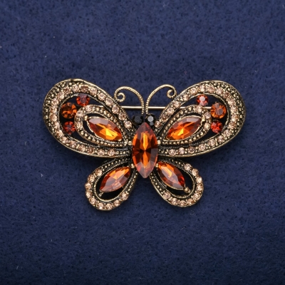 Брошка Метелик з коричневими каменями 34х54мм жовтий метал