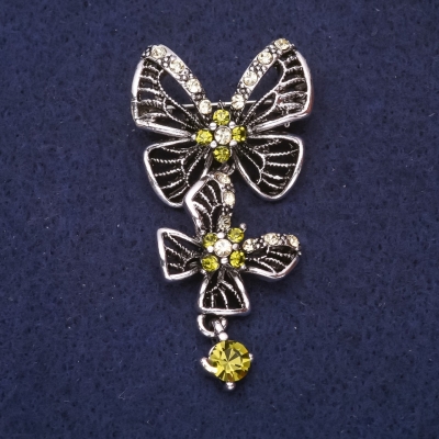 Брошка Метелик із зеленими стразами 56х28мм сріблястий метал