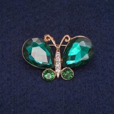 Брошка Метелик з зеленими і білими кристалами, золотистий метал 23х34мм