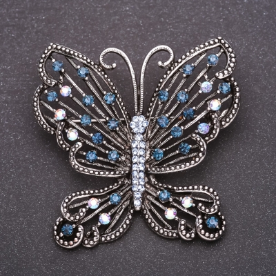Брошка Метелик з синіми стразами 53х54мм сірий метал