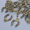 Pendant Finding "Horseshoe", diameter 15×11mm, hole diameter 1.9mm, packaging 24 pcs±, bronze metal color