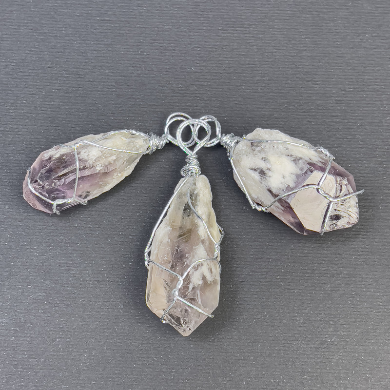 Amethyst Pendant Uncut in a Weave, assortment diameter from 16x40mm to 18x48mm+