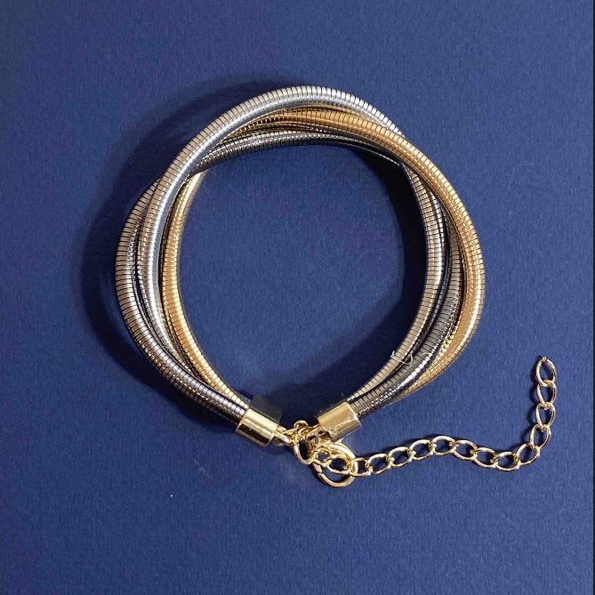 Triple bracelet in three metals: gold-tone, silver-tone, and gray metal with extension chain