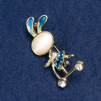Brooch 'Hare on a Scooter' with White Crystals, Gold-Toned Metal, Blue Enamel, Cabochon Cat's Eye (White) 43x21mm +