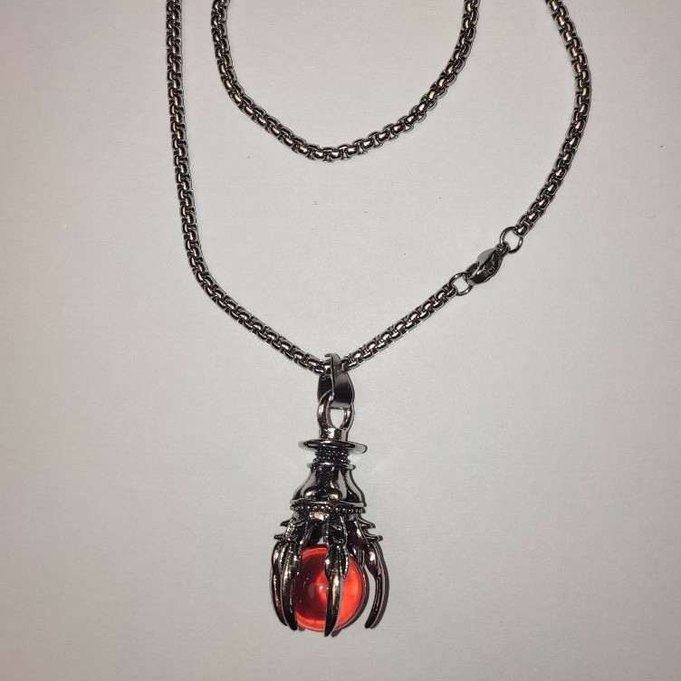 Pendant “Sphere in the Paw” orange 40×18 mm on a chain, approx 70 cm + - silver-colored metal